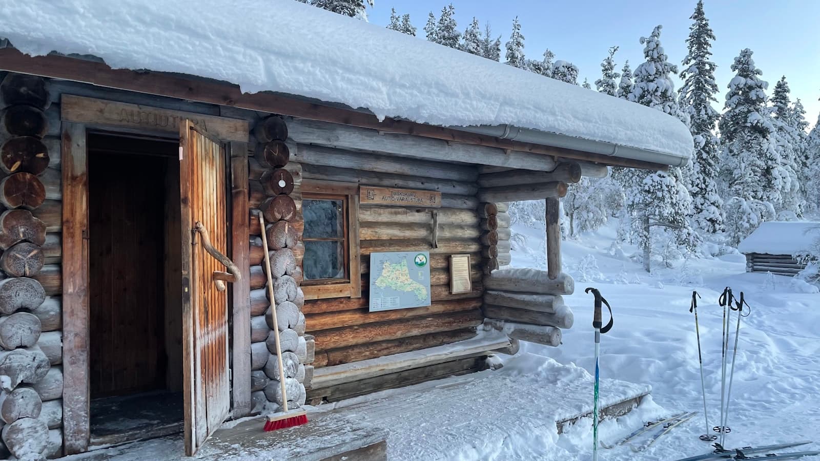 Snow-laden cabin roof in pine forest near Panguitch, Utah, served by Zenic Industries roofing.