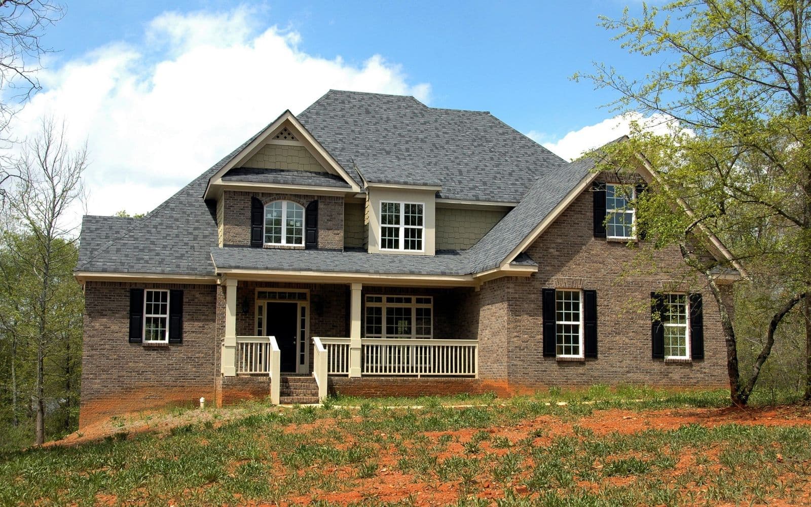 Two-story Parowan, Utah home with a durable new pitched roof by Zenic Industries roofing.