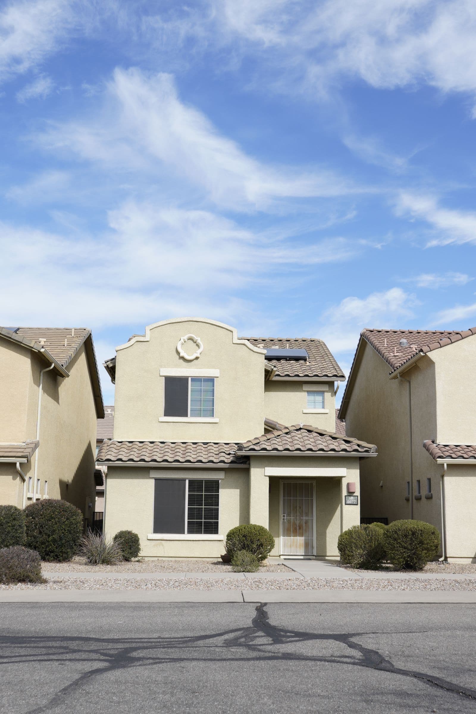 Sun-baked desert home with a new roof under a bright sky in St. George, Utah, by Zenic Industries roofing.